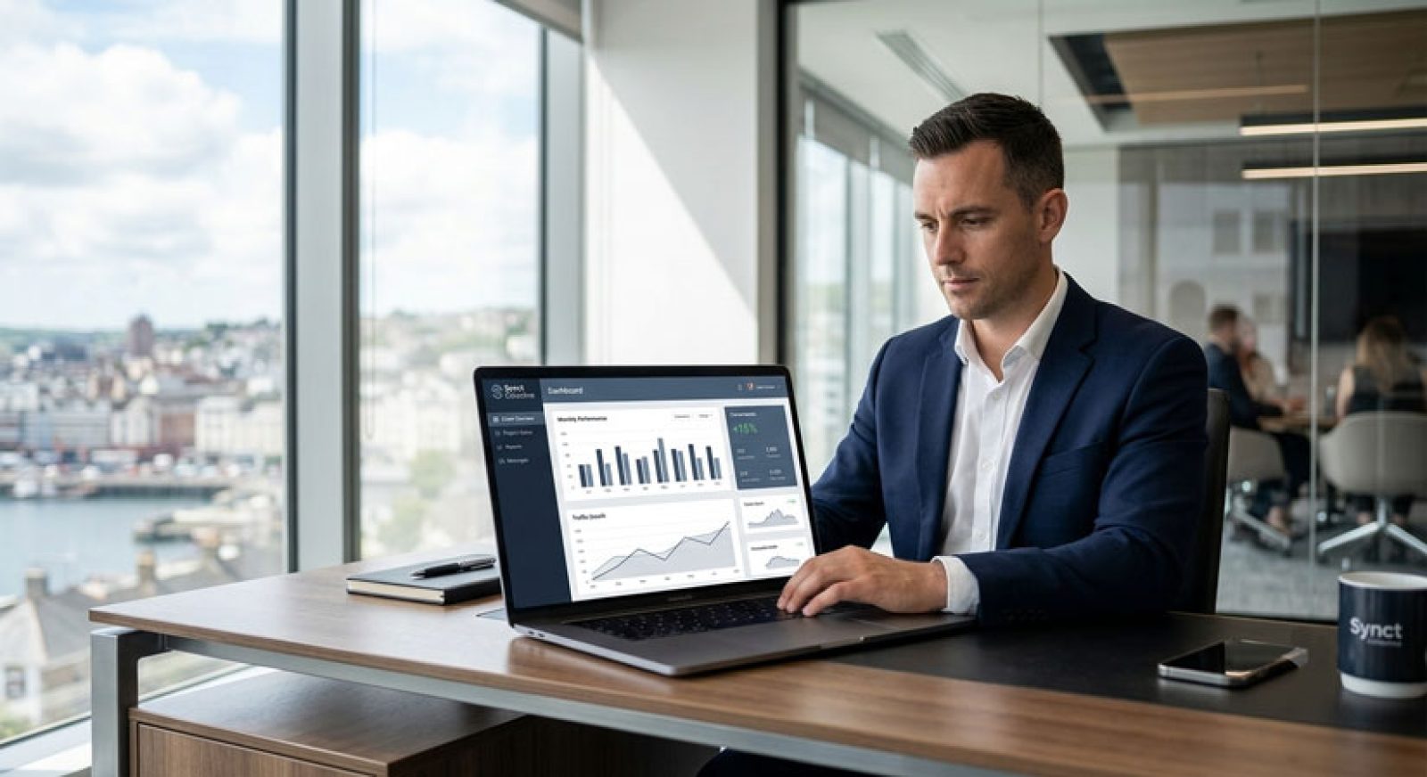 A business professional working on a laptop displaying a custom WordPress client portal and data dashboard in a modern office